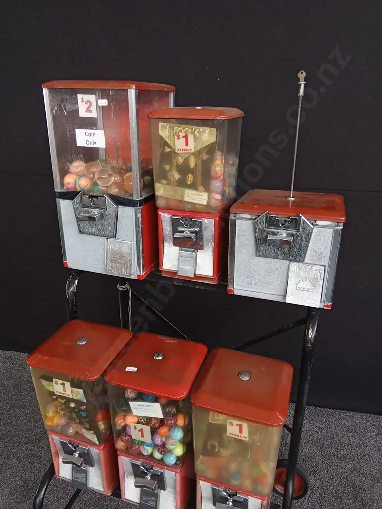 NORTHWESTERN BRAND TOY VENDING MACHINE SET ON STEEL TROLLEY. 6 MACHINES, 1 INCOMPLETE. COIN MECHANISMS BUT NO KEYS, Image 1++