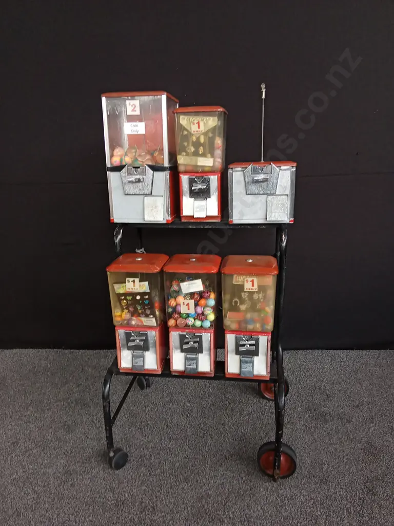 NORTHWESTERN BRAND TOY VENDING MACHINE SET ON STEEL TROLLEY. 6 MACHINES, 1 INCOMPLETE. COIN MECHANISMS BUT NO KEYS, Image 1++