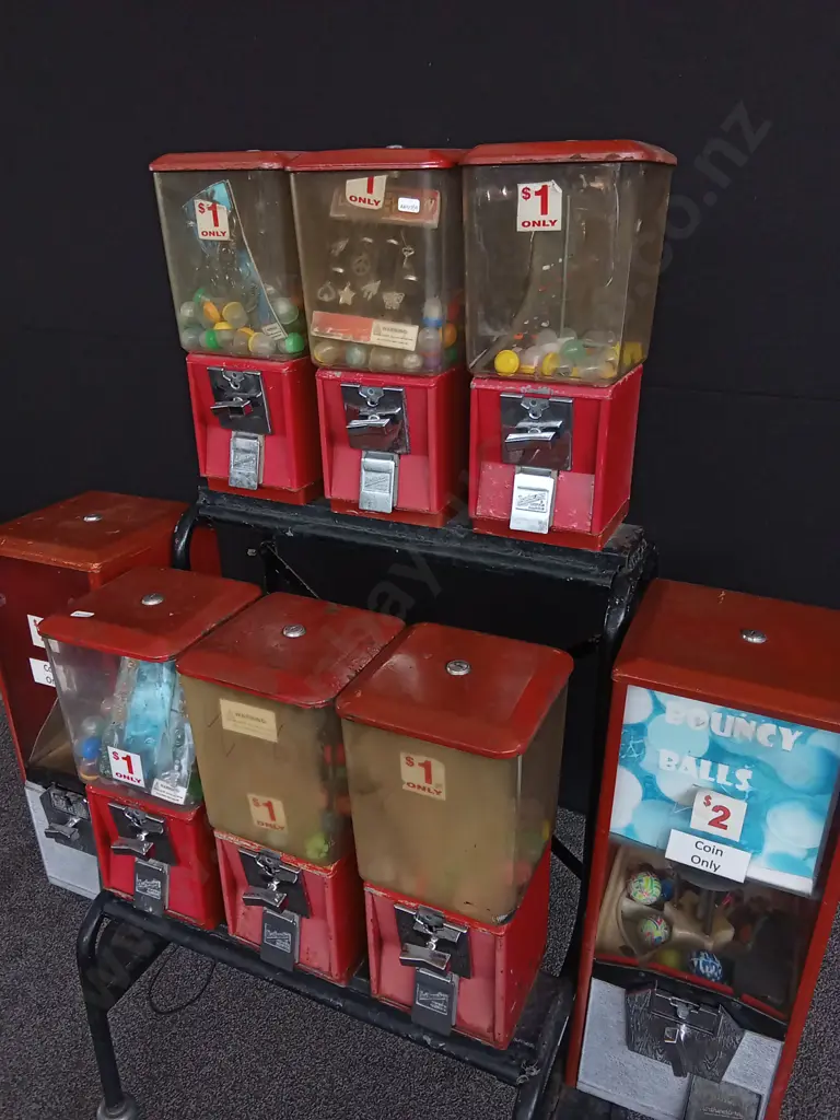 NORTHWESTERN BRAND TOY VENDING MACHINES 8 ATTACHED TO TROLLEY, ALL WITH COIN MECHANISM BUT NO KEYS Image 1++