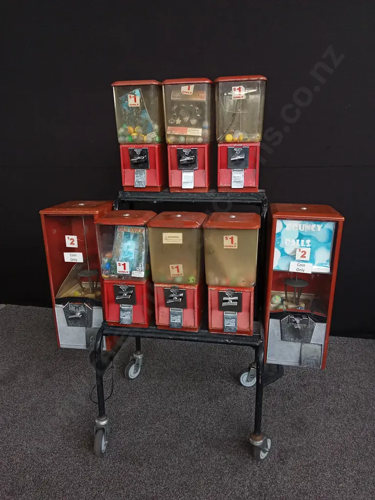 NORTHWESTERN BRAND TOY VENDING MACHINES 8 ATTACHED TO TROLLEY, ALL WITH COIN MECHANISM BUT NO KEYS Image 1++