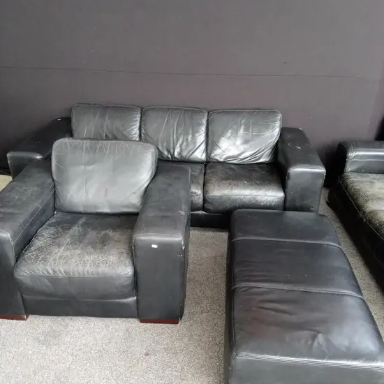 BLACK LEATHER LOUNGE SUITE VERY COMFORTABLE BUT NEEDS RESTORATION - 3 SEATER, 2 SEATER PLUS ARMCHAIR AND FOOT STOOL