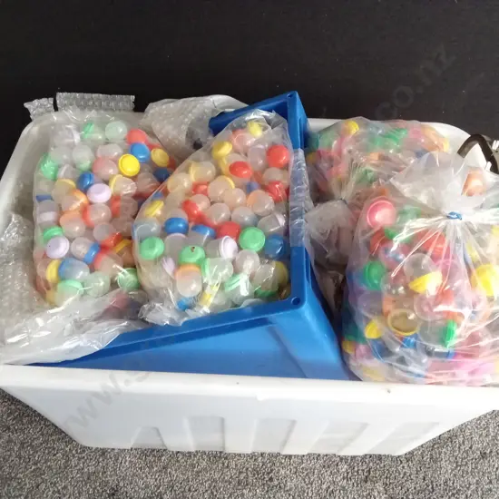 BOX OF PLASTIC CAPSULES FILLED WITH COSTUME JEWELLERY AND OTHER ITEMS