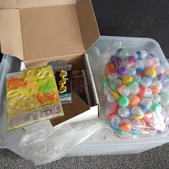 BOX OF PLASTIC CAPSULES FILLED WITH COSTUME JEWELLERY AND OTHER ITEMS