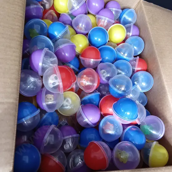 BOX OF PLASTIC CAPSULES FULL OF ASSORTED TOYS FOR VENDING MACHINE
