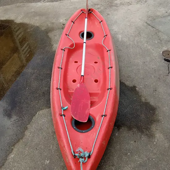 RED KAYAK WITH PADDLE