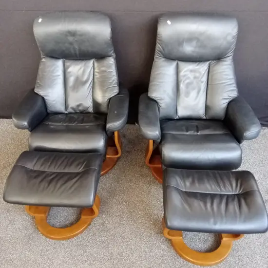 2 ROTATING BLACK LEATHER RECLINERS WITH MATCHING FOOT STOOLS
