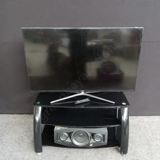 TV STAND WITH A SAMSUNG TV AND SONY SPEAKER BOTH TESTED AND WORKING