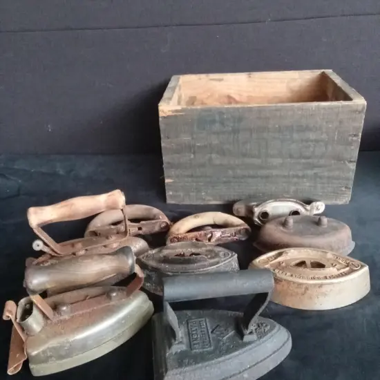 9 CAR IRON ITEMS IN A WOODEN BOX