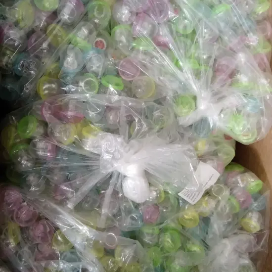 BOX OF PLASTIC CAPSULES FULL OF COSTUME JEWELLERY FOR VENDING MACHINE