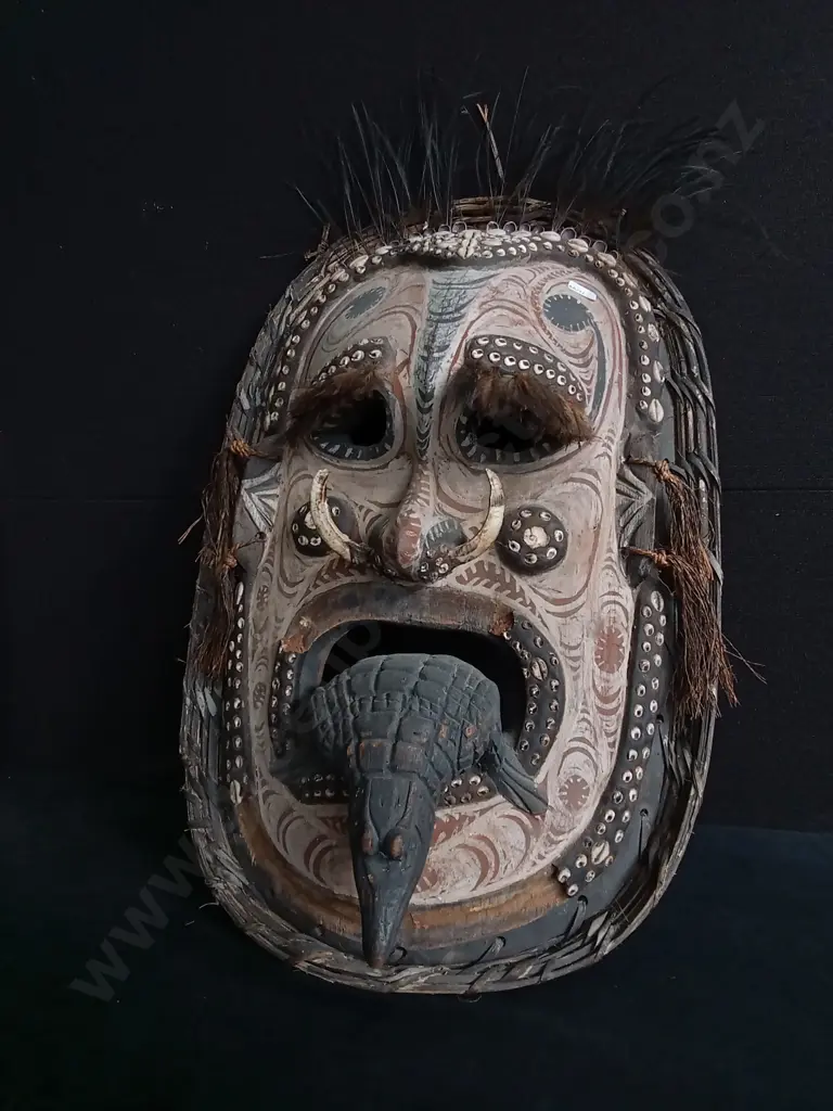PAPUA NEW GUINEA SEPIK RIVER MASK CRAFTED WITH WOVEN FIBER, COWRIE SHELLS, AND BOAR TUSKS Image 1++