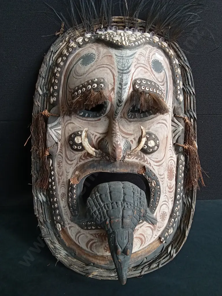 PAPUA NEW GUINEA SEPIK RIVER MASK CRAFTED WITH WOVEN FIBER, COWRIE SHELLS, AND BOAR TUSKS Image 1++