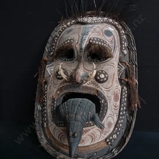 PAPUA NEW GUINEA SEPIK RIVER MASK CRAFTED WITH WOVEN FIBER, COWRIE SHELLS, AND BOAR TUSKS