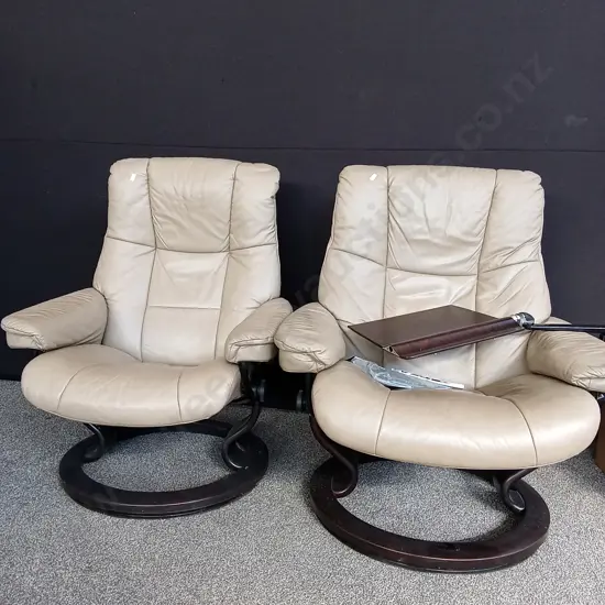 PAIR OF "STRESSLESS" BRAND RECLINING LEATHER SWIVEL ARMCHAIRS ONE WITH A MOVEABLE TABLE ATTATCHED