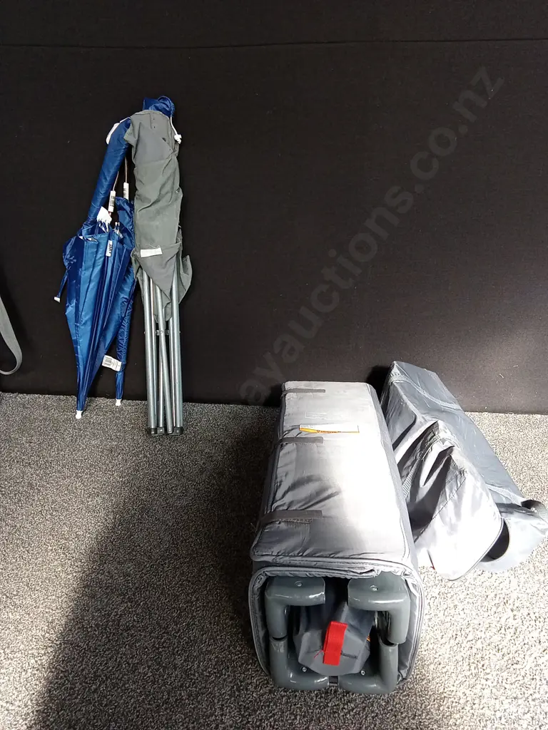 TRAVEL COT ON WEELS AND A CAMPING CHSIR WITH CLIP ON UMBRELLAS Image 1++
