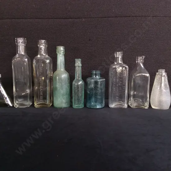 COLLECTION OF 10 VINTAGE AND ANTIQUE GLASS BOTTLES, INCLUDING MEDICINE, SODA, AND APOTHECARY BOTTLES