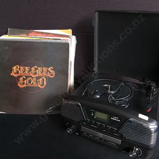 RETRO MUSIC CENTER WITH VINYL TYRNTABLE, CD PLAYER, AND STACK OF VINTAGE VINYL