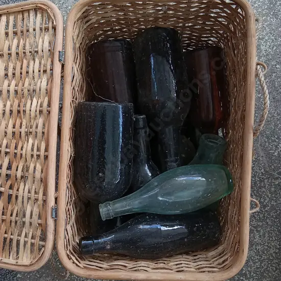 WICKER BASKET FULL OF VINTAGE GLASS BOTLLES, H 33 CM X W 41 CM