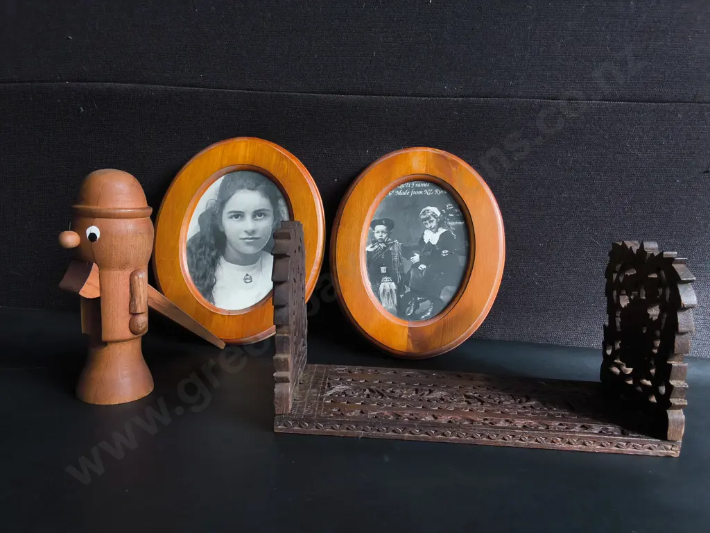 VINTAGE HAND CARVED WOODEN EXPLANDING BOOK STAND, WOODEN NUTCRACKER FIGURINE, AND PAIR OF FRAMED PHOTOGRAPHS Image 1++