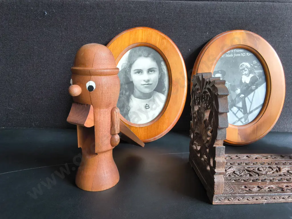VINTAGE HAND CARVED WOODEN EXPLANDING BOOK STAND, WOODEN NUTCRACKER FIGURINE, AND PAIR OF FRAMED PHOTOGRAPHS Image 1++