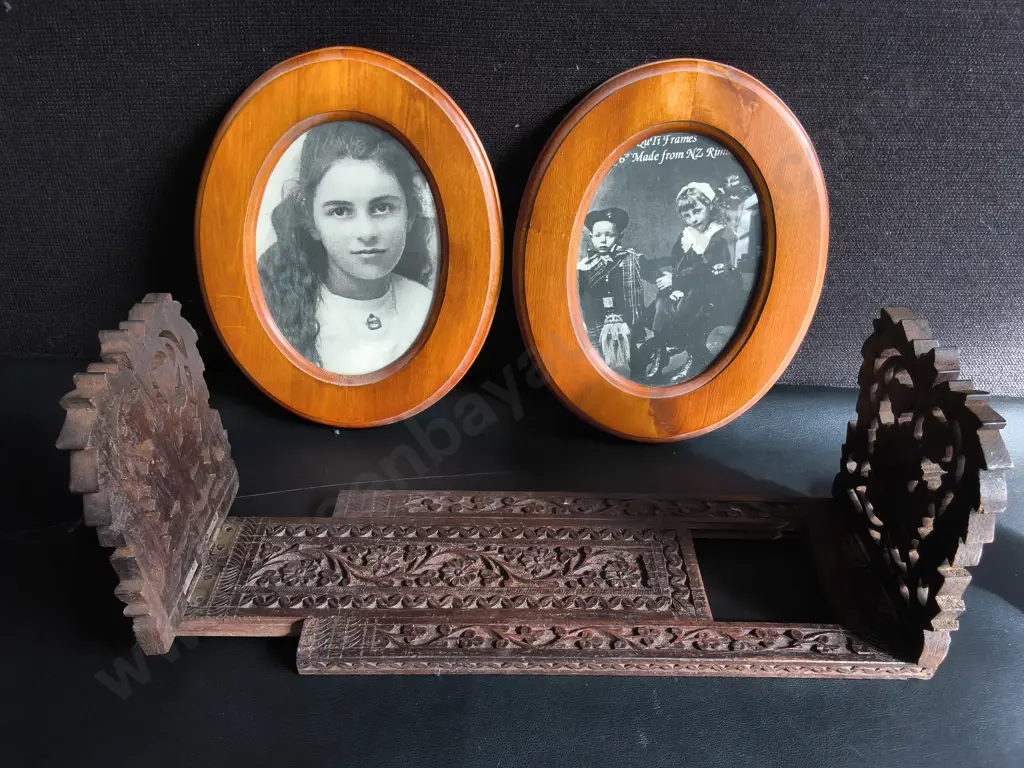 VINTAGE HAND CARVED WOODEN EXPLANDING BOOK STAND, WOODEN NUTCRACKER FIGURINE, AND PAIR OF FRAMED PHOTOGRAPHS Image 1++