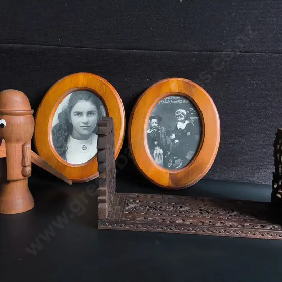 VINTAGE HAND CARVED WOODEN EXPLANDING BOOK STAND, WOODEN NUTCRACKER FIGURINE, AND PAIR OF FRAMED PHOTOGRAPHS