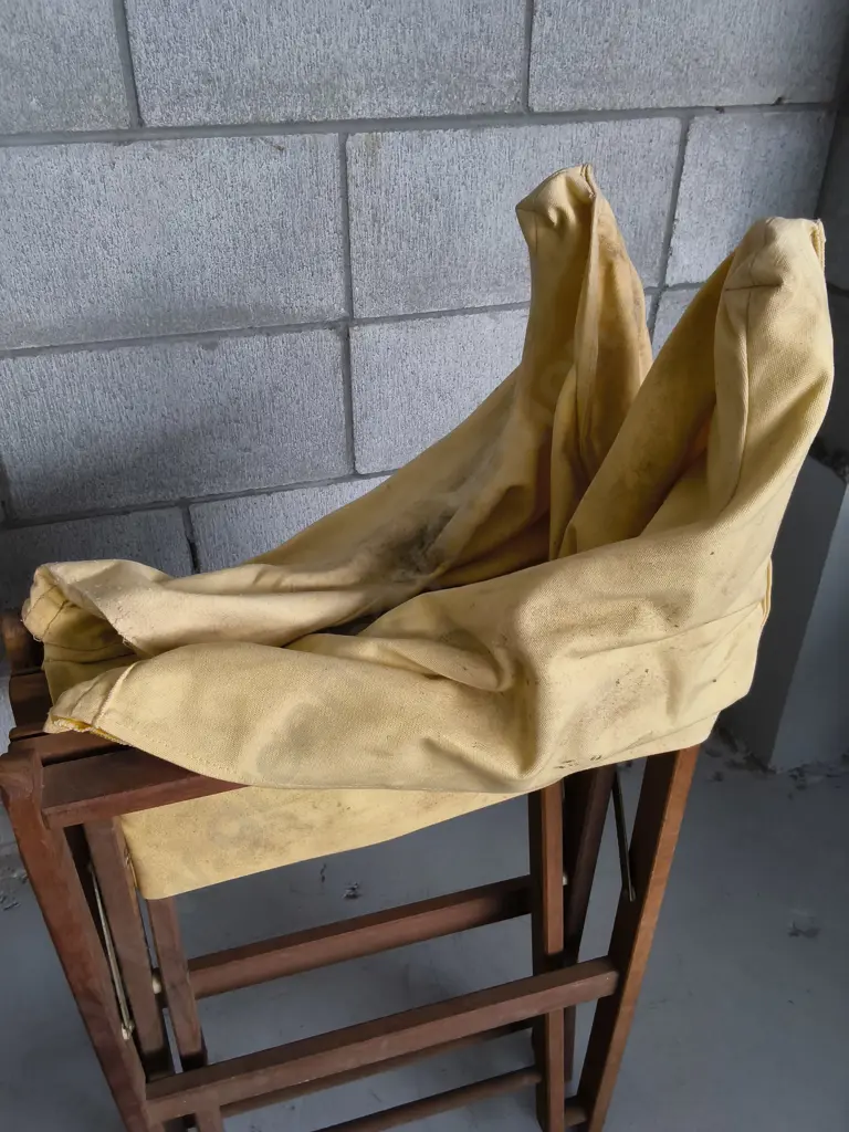 PAIR OF WOODEN FOLDING DIRECTORS CHAIRS WITH YELLOW FABRIC COVERS, DAMAGE PICTURED Image 1++