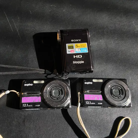 3 DIGITAL CAMERAS, SONY, ANDXOAIR OF SANYO, UNTESTED