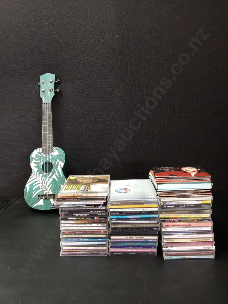 COLLECTION OF CDS AND A UKELELE Image 1++
