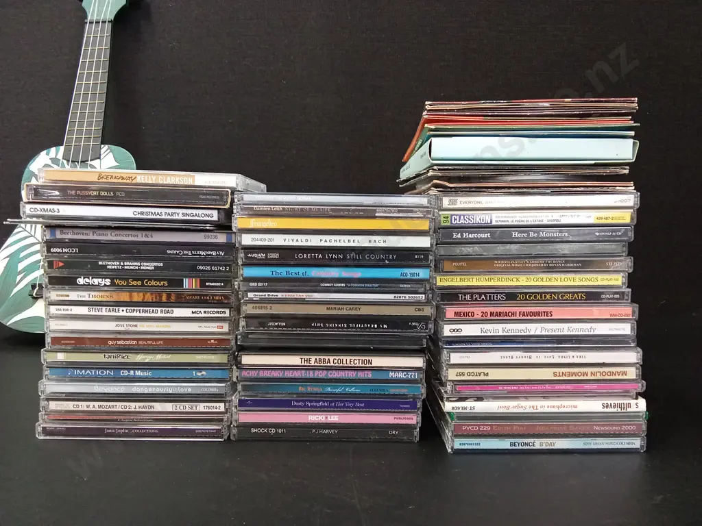 COLLECTION OF CDS AND A UKELELE Image 1++