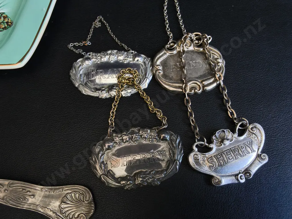 COLLECTION OF VINTAGE TABLEWARE, INCLUDING SERVING FORK AND SPOON SET, TURQUOISE DISH, AND DECANTER LABELS Image 1++