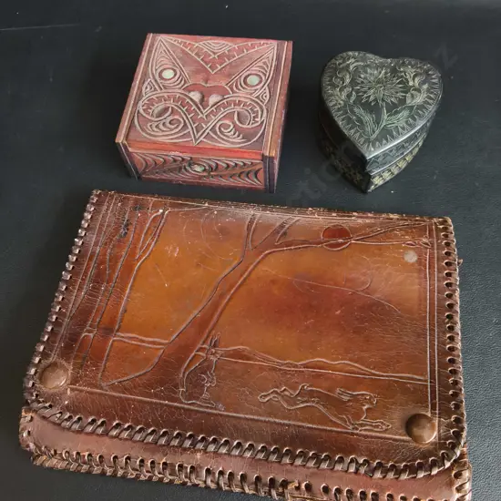 VINTAGE HAND TOOLED BROWN LEATHER POUCH, MĀORI CARVED WOOD BOX, AND ENGRAVED HEART TRINKET BOX, WIDEST W 22 CM