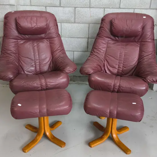 PAIR OF VINTAGE BURGUNDY LEATHER RECLINER AND OTTOMAN SETS