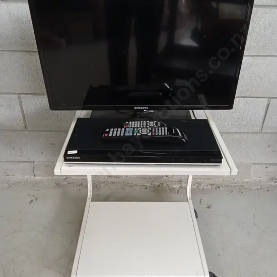 SAMSUNG TV STATION ON WHEELS, 26", INCLUDING WORKING DVD PLAYER AND CORD POUCH.