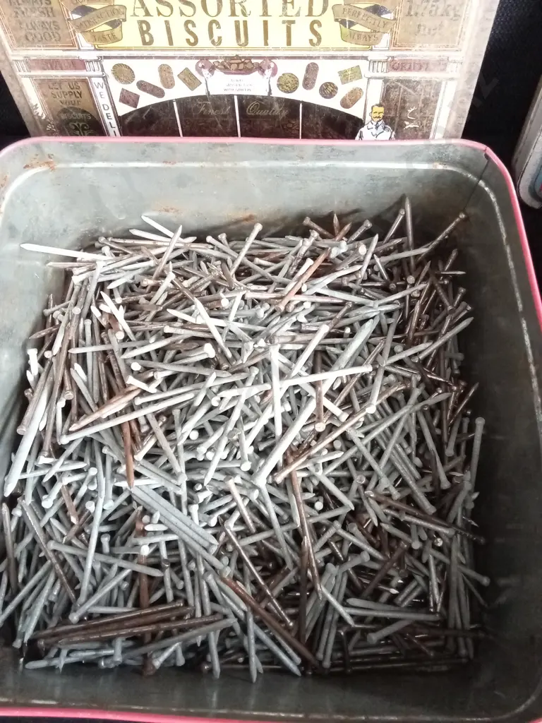 TWO BISCUIT TINS FULL OF NAILS Image 1++