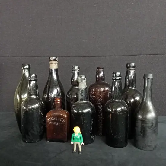 COLLECTION OF ANTIQUE GLASS BOTTLES X 10 AND A LITTLE WOMAN